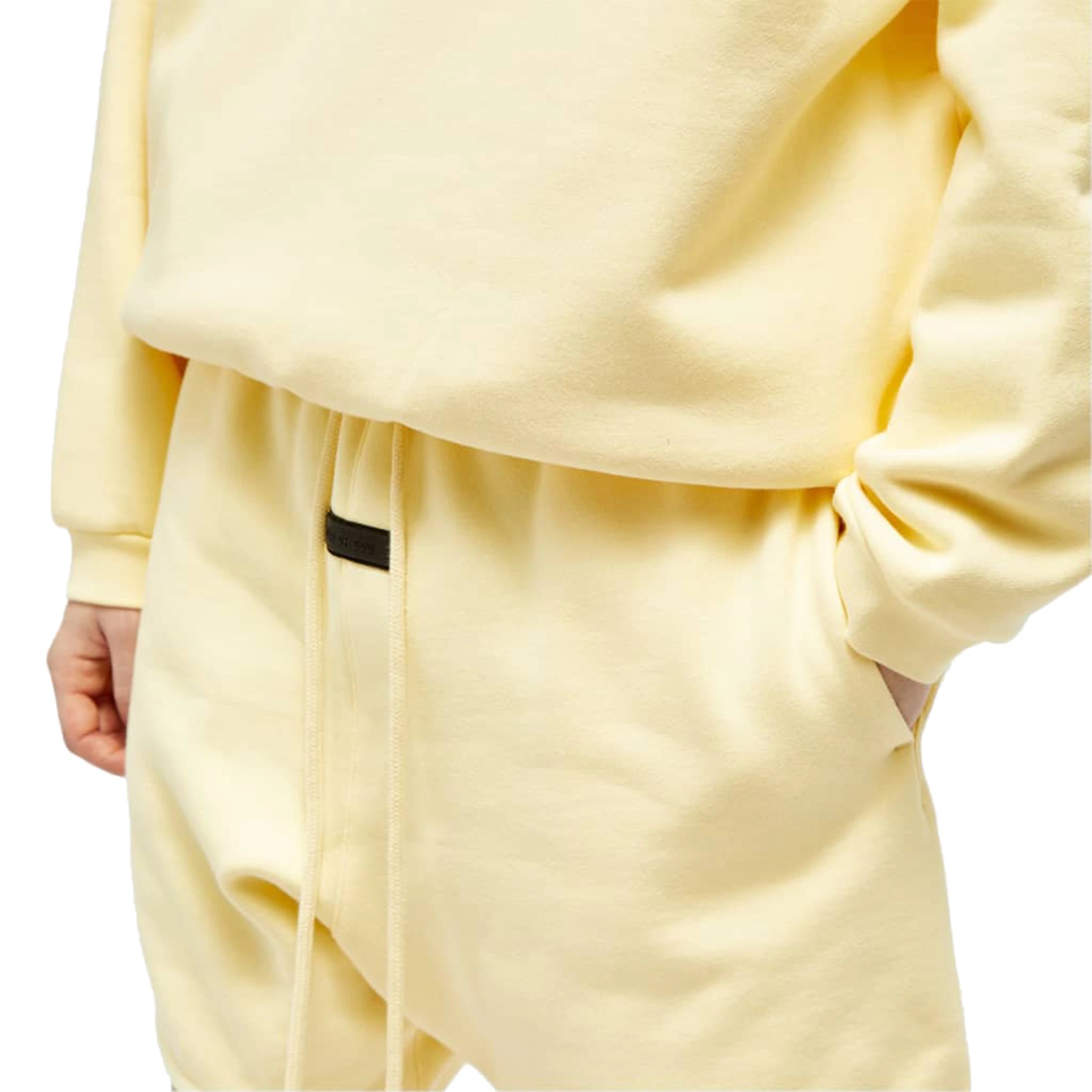 Model detail view of Fear Of God Essentials Garden Yellow Shorts (FW23) 125SP244191F
