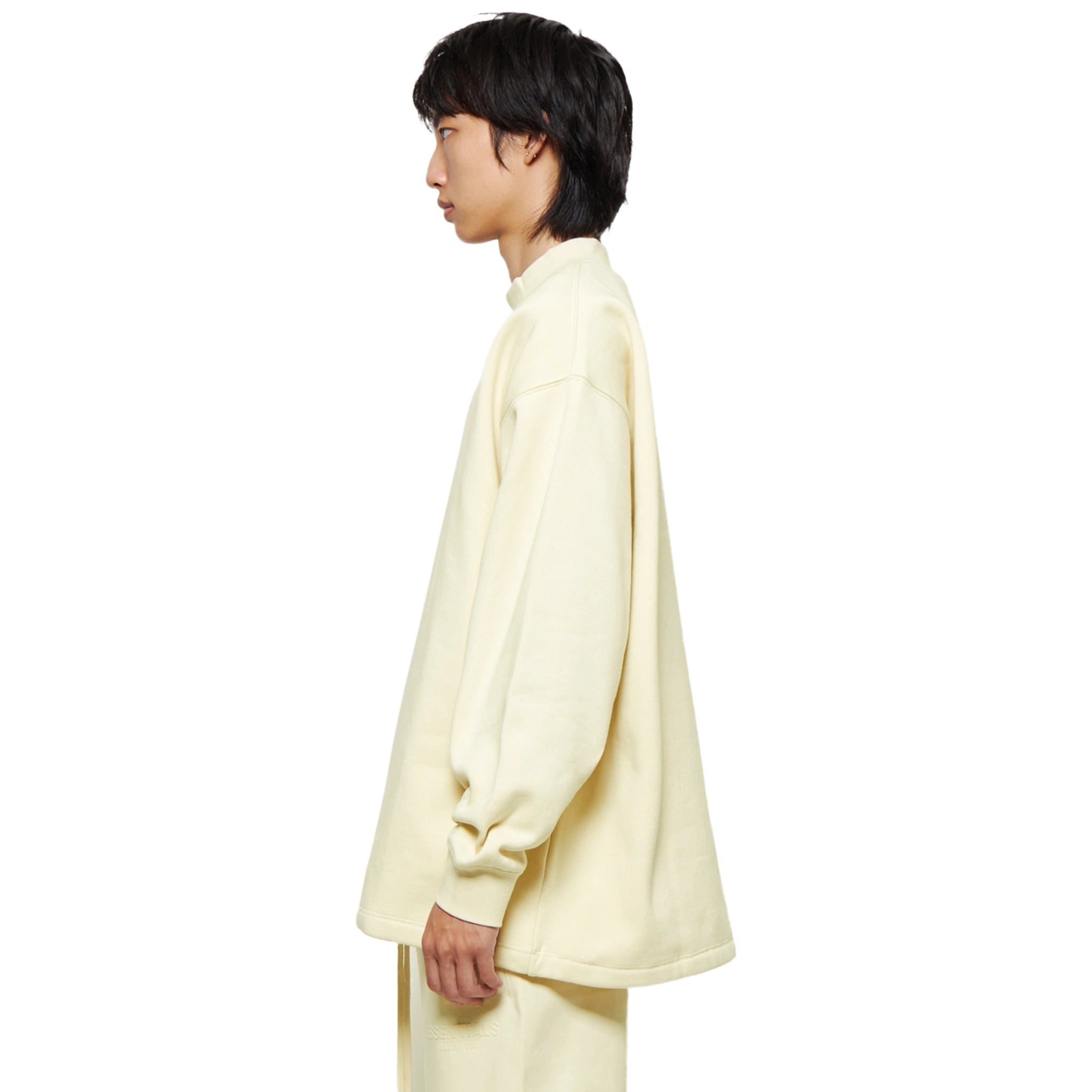 Model side view of Fear Of God Essentials Relaxed Egg Shell Crewneck