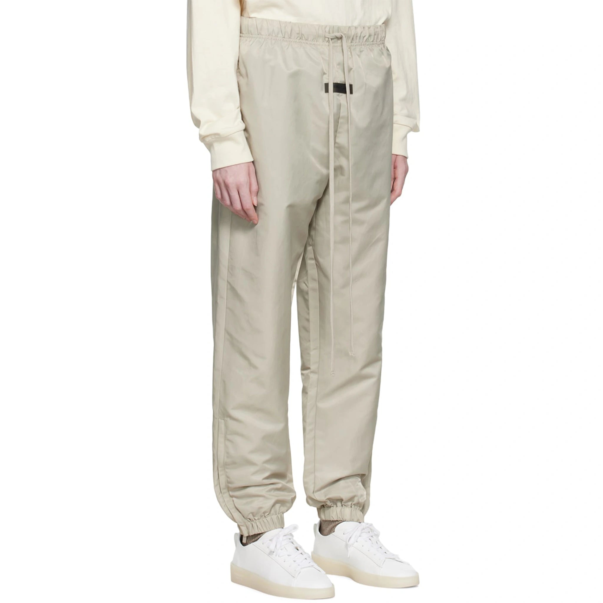 Model side view of Fear Of God Essentials Smoke Track Pants (FW22) 130SU222161F