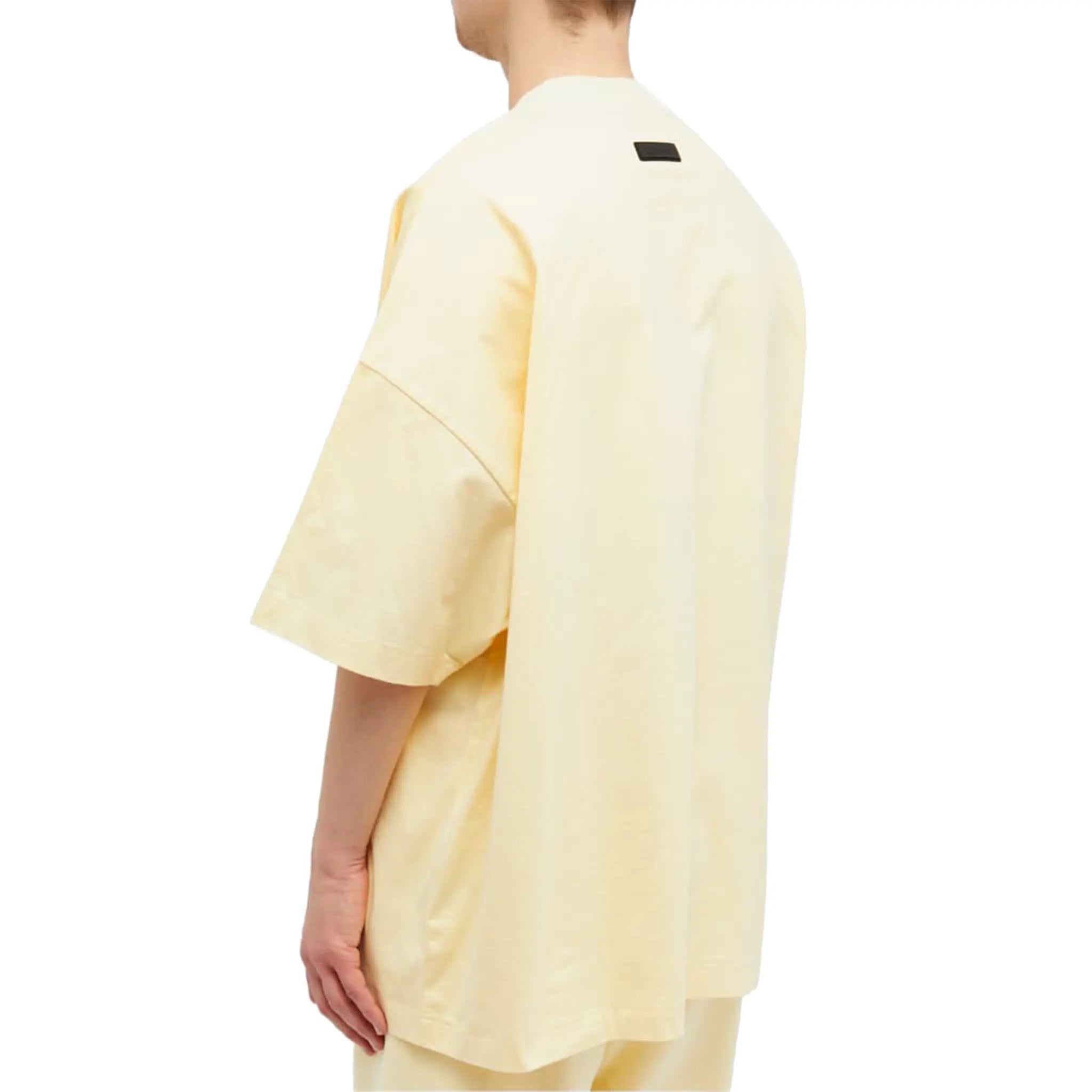 Model back view of Fear of God Essentials SS Garden Yellow T Shirt (FW23) 125SP244191F