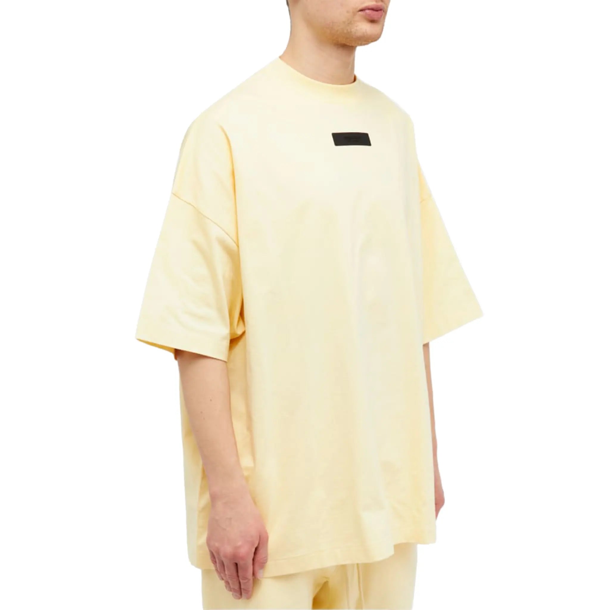 Model side view of Fear of God Essentials SS Garden Yellow T Shirt (FW23) 125SP244191F