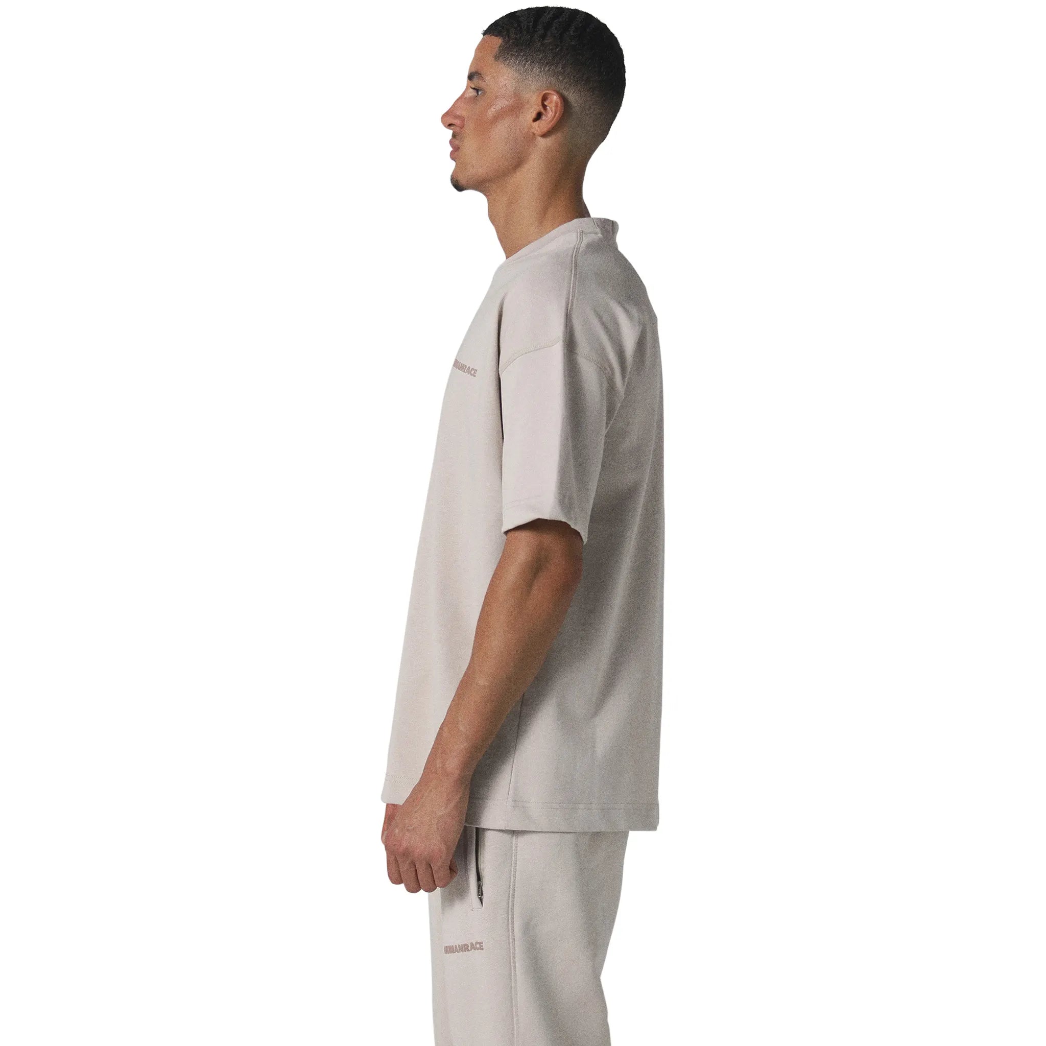 Model male side view of Human Race Space Deep Taupe T Shirt