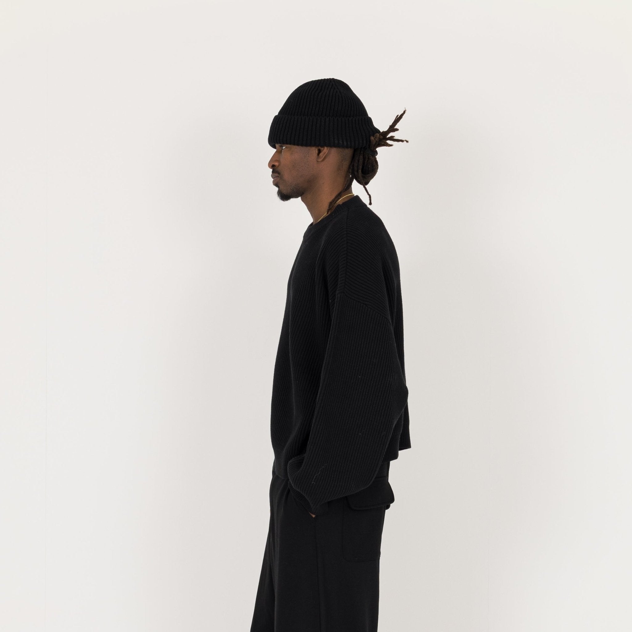 Model Side view of Destructive Ribbed Black Beanie