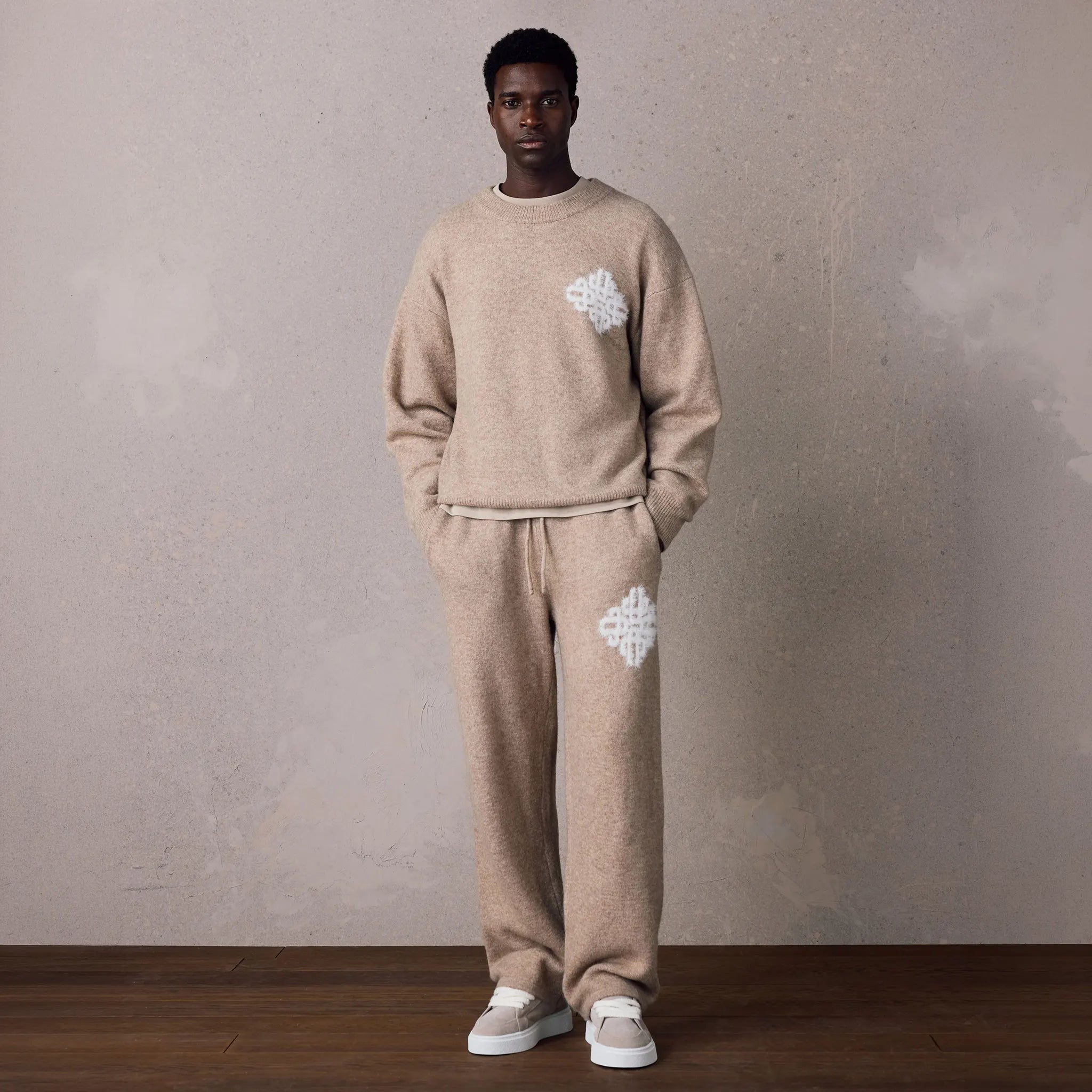 Model View of The Couture Club Emblem Fluffy Knit Beige Sweatpants