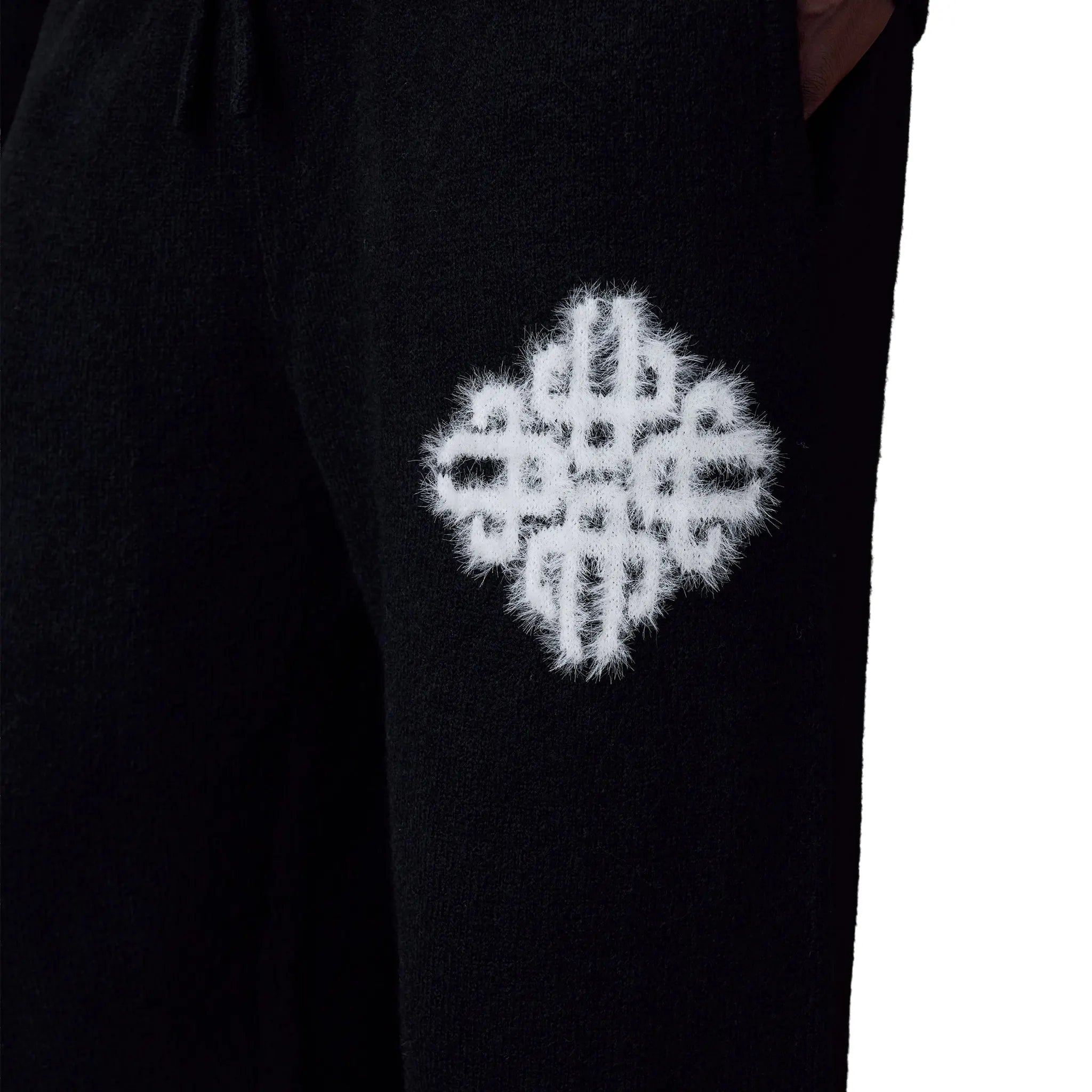 Detailed Front View of The Couture Club Emblem Fluffy Knit Black Sweatpants