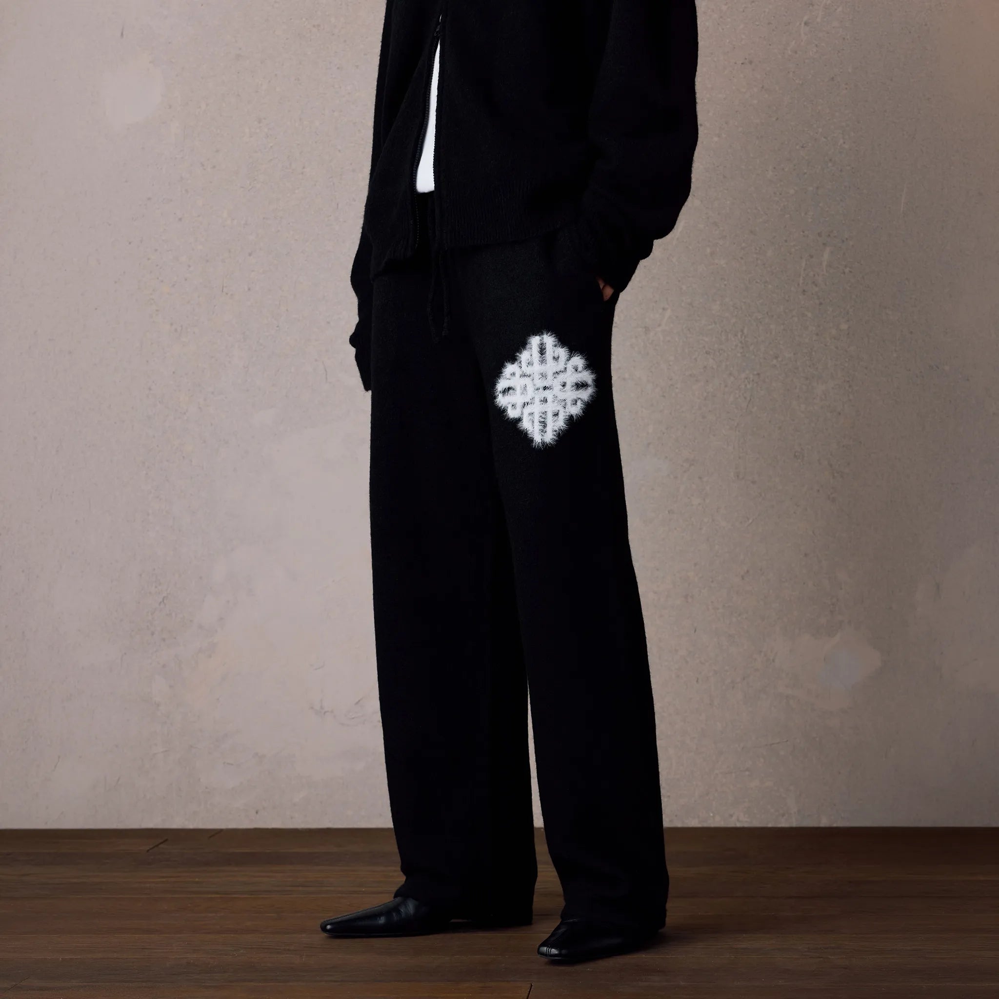 Front Side View of The Couture Club Emblem Fluffy Knit Black Sweatpants