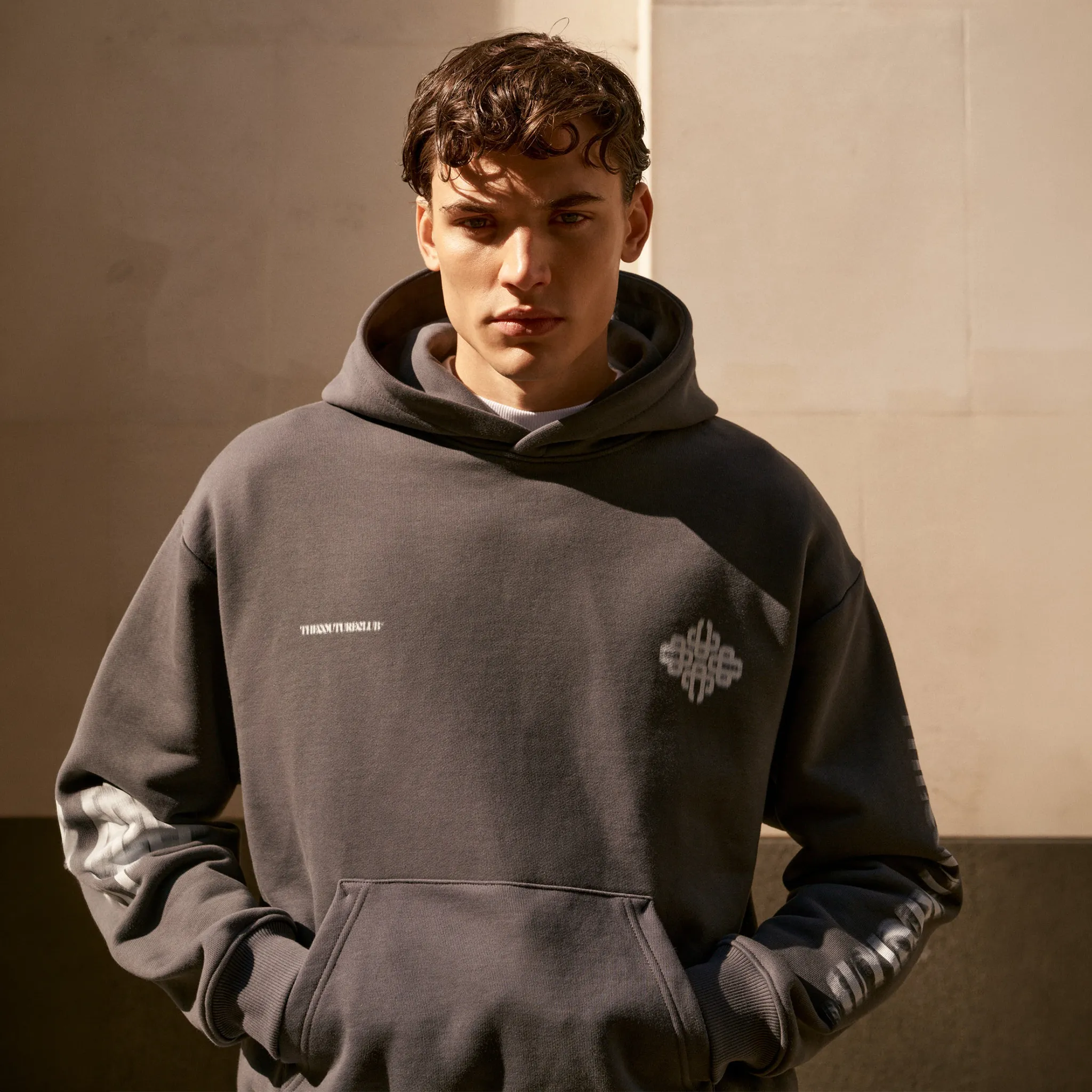 Front View of the couture club motion blurred emblem charcoal hoodie tccm2978