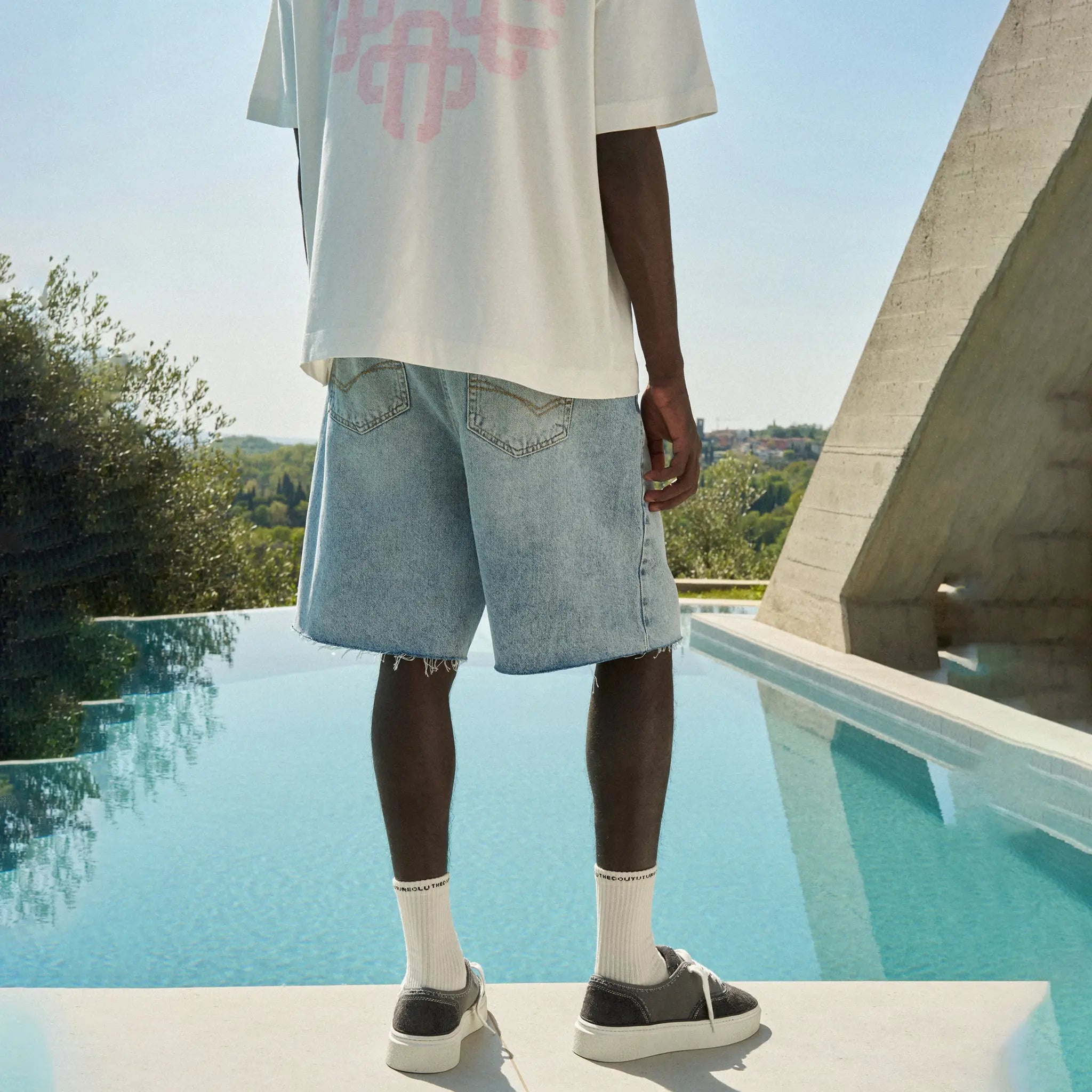 Back View of The Couture Club Raw Edge Mid Stone Wash Denim Shorts