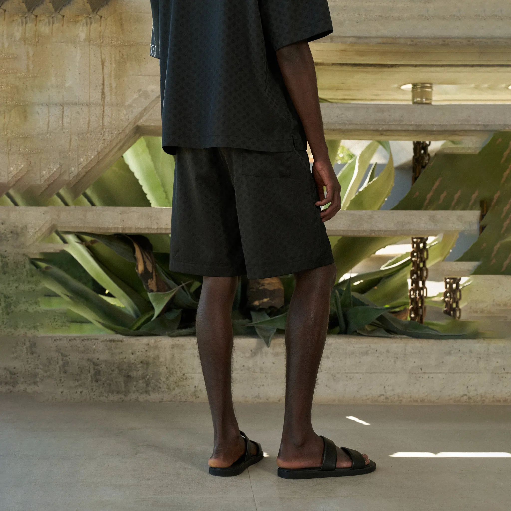 Back Side View of The Couture Club Satin Jacquard Black Shorts