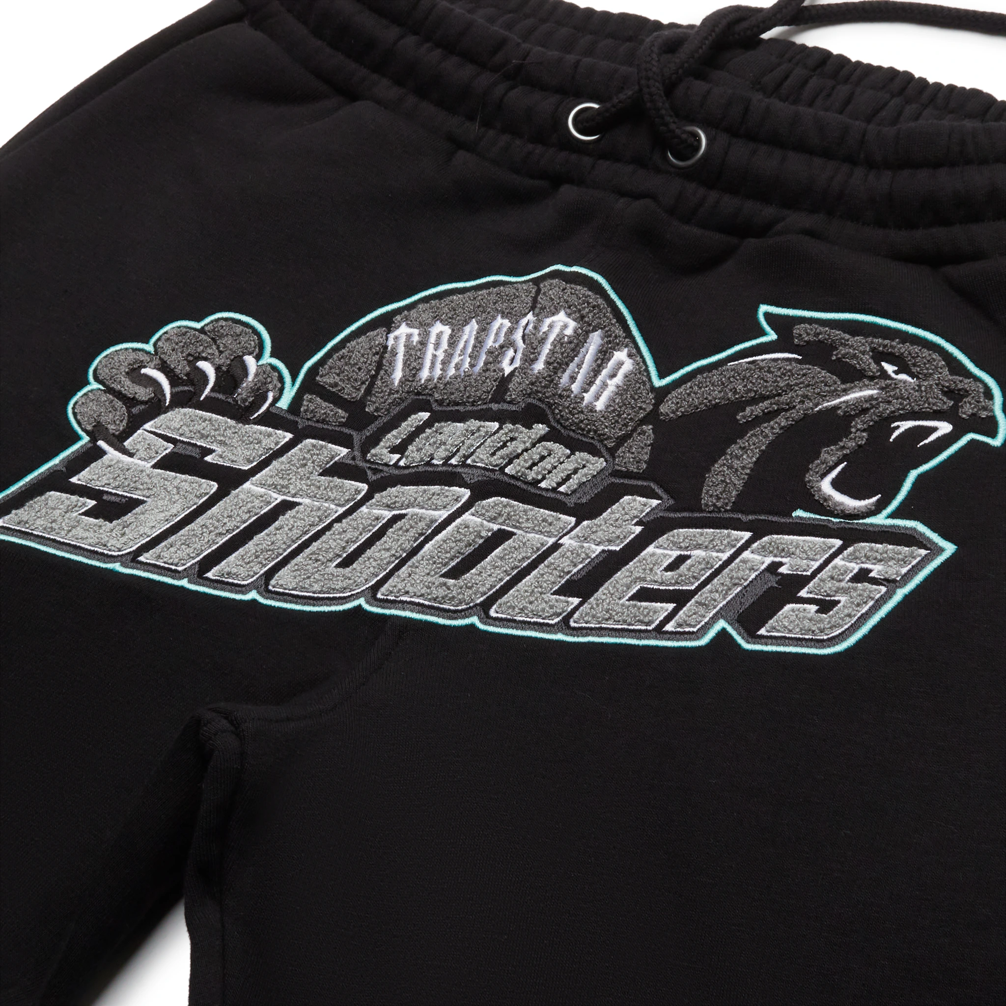 Logo view of Trapstar Shooters Black Teal Tracksuit